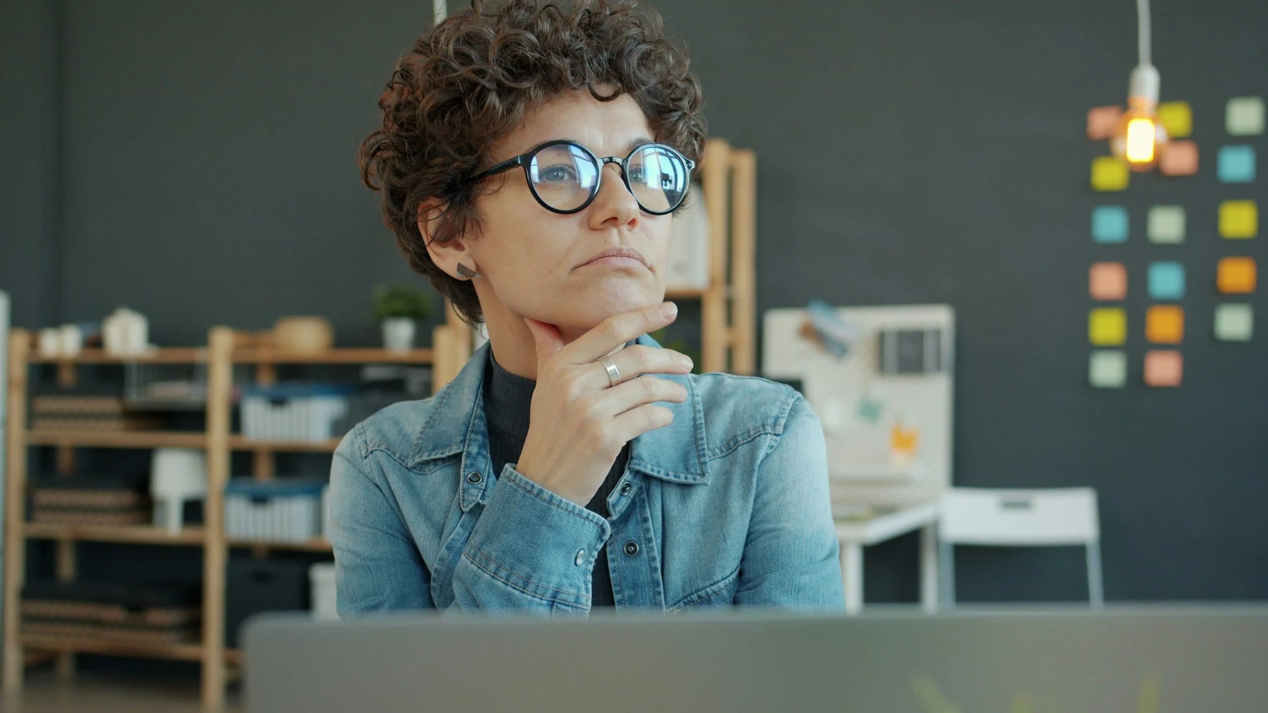 Woman looking sceptically at a laptop screen, checking an AI answer before trusting it