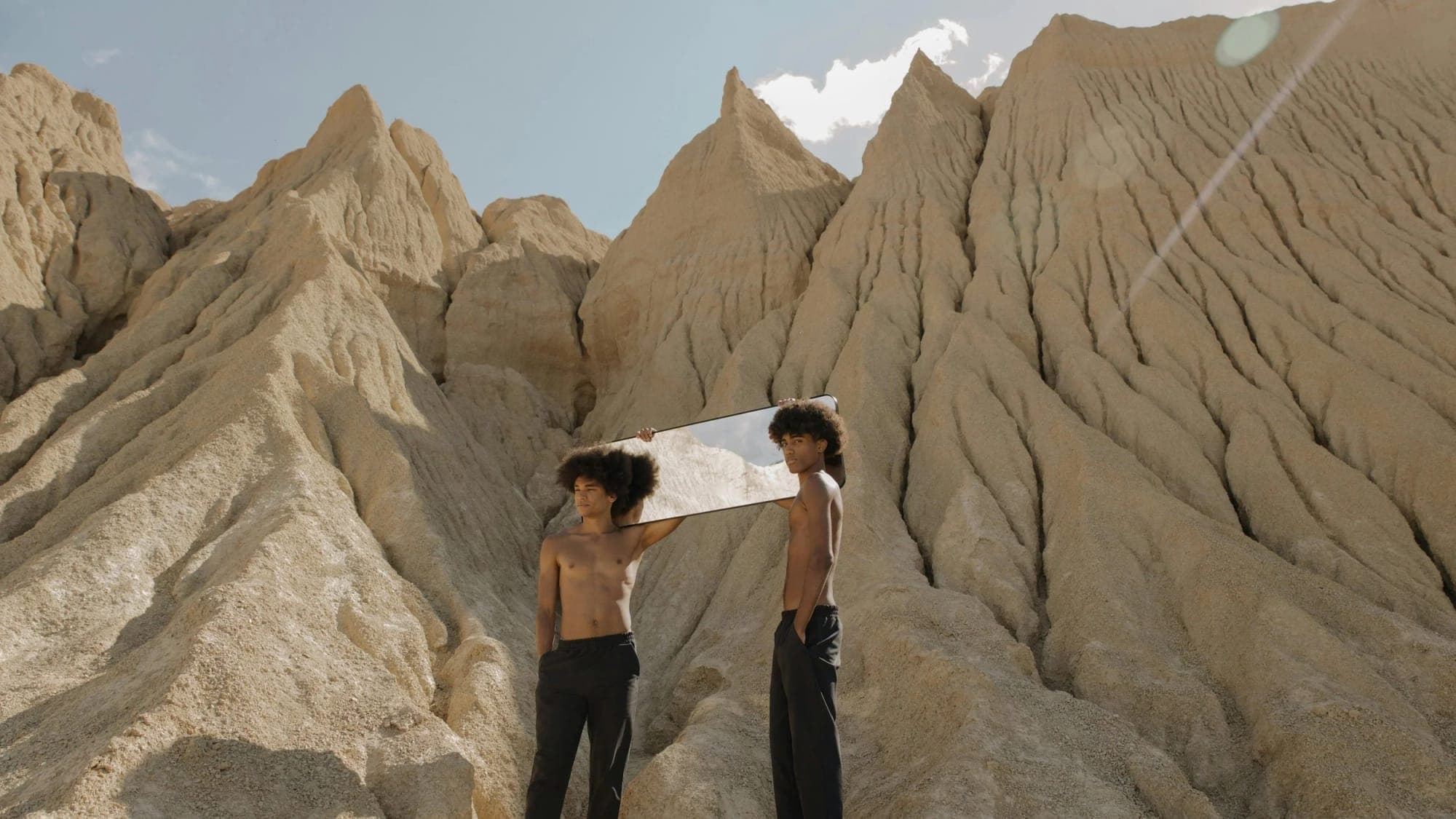 Two people standing in a desert canyon