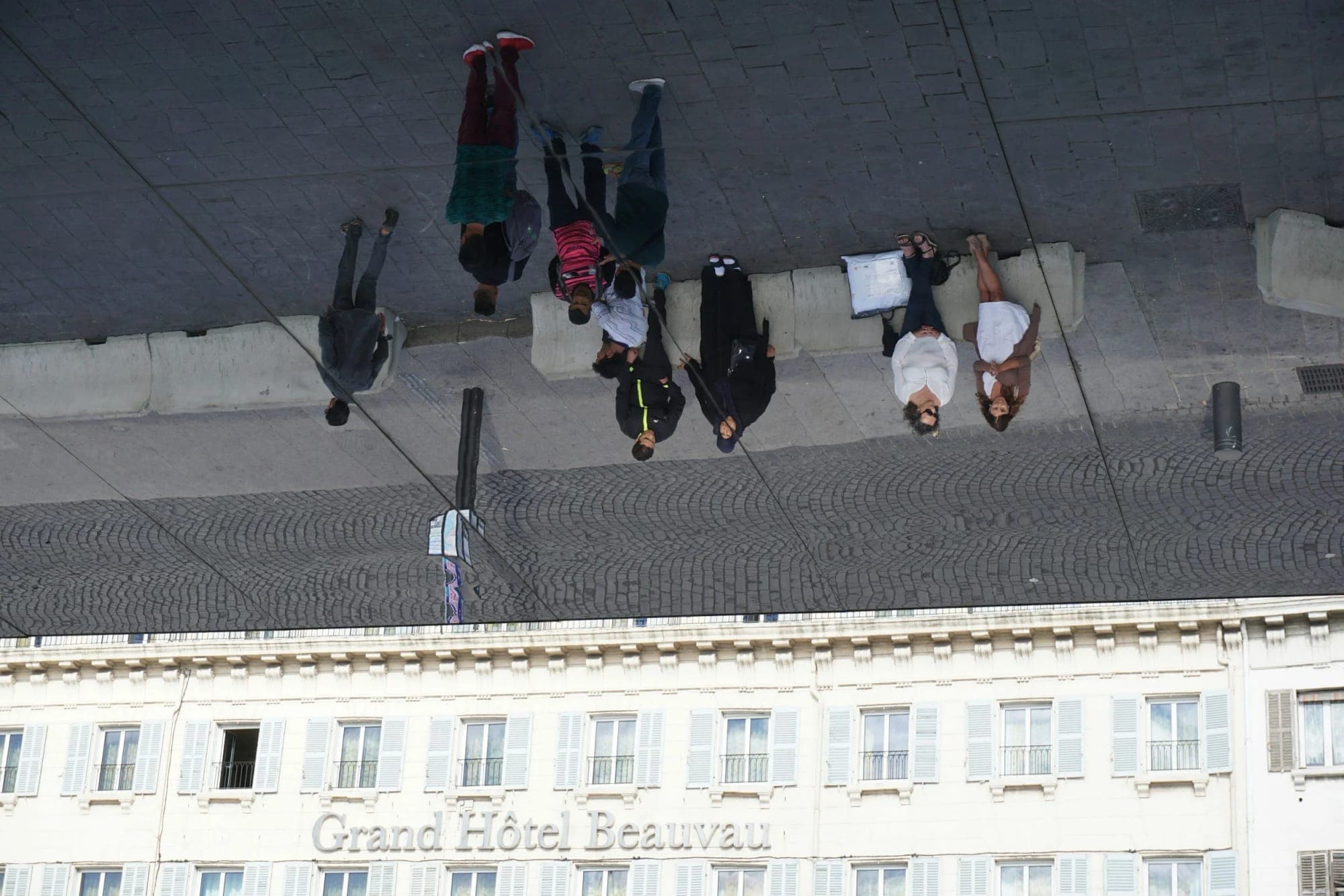 Upside-down view of people walking along a city street