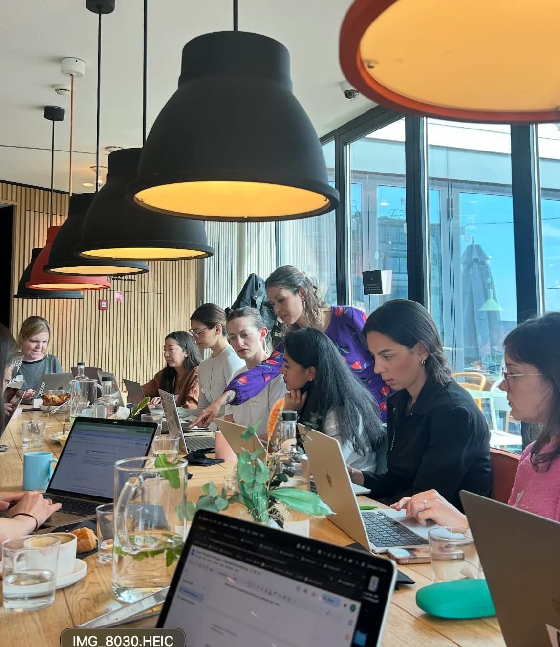 Participants at laptops during an AI workshop for teams in Amsterdam