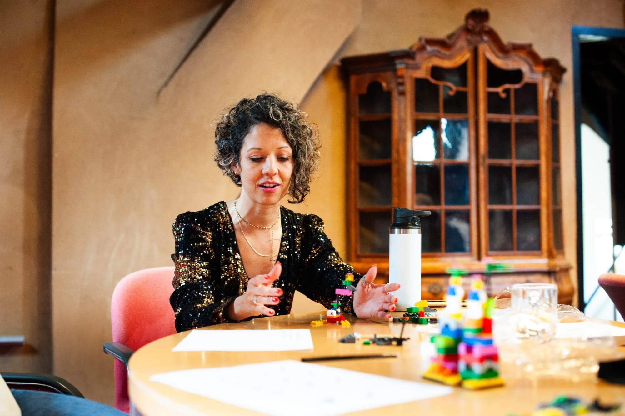 Rafaela Buena facilitating a LEGO® Serious Play® session at a table
