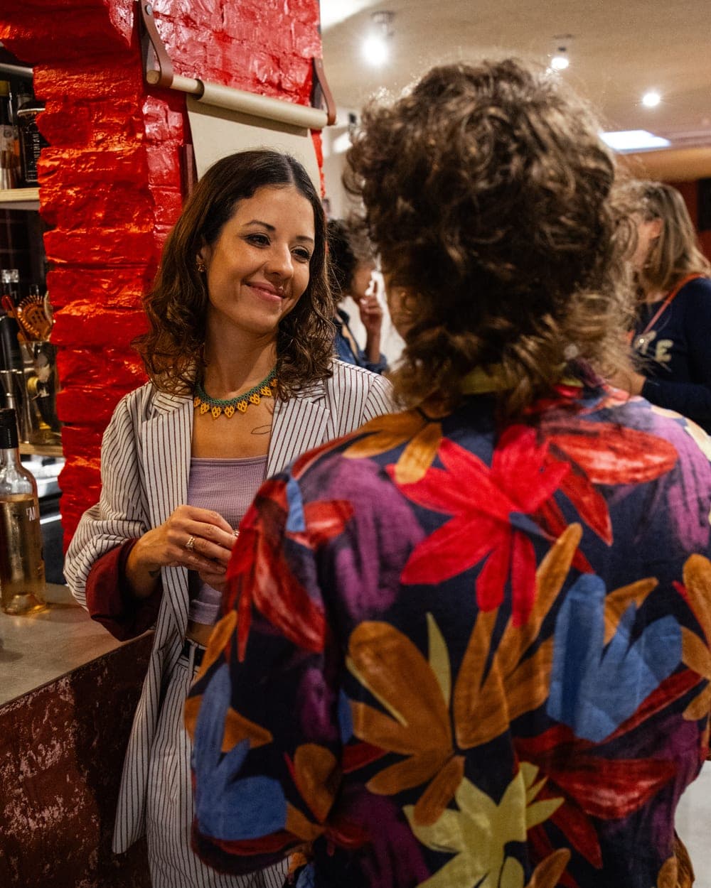Rafaela Buena smiling as she welcomes a guest at Tummy Talks by Gigi in Amsterdam