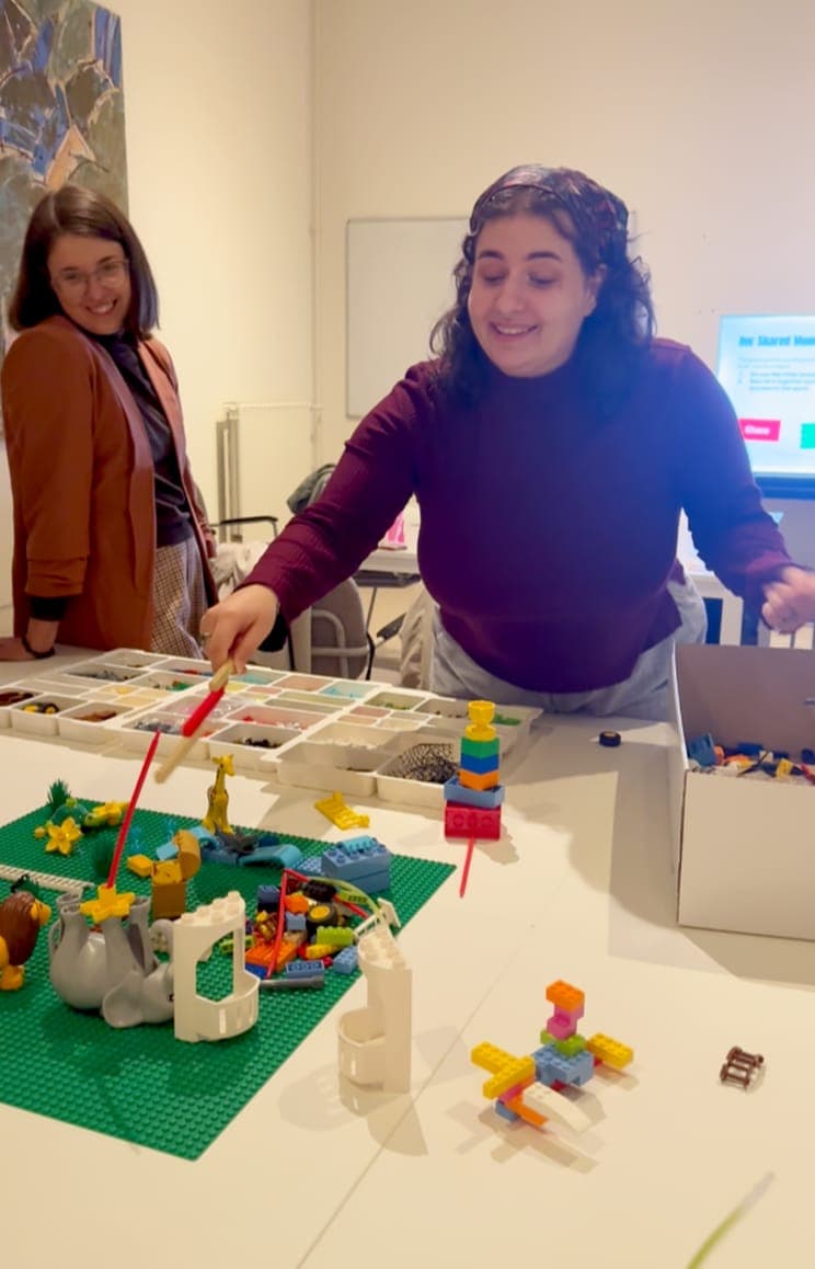 Participants sharing their LEGO® Serious Play® models around a table