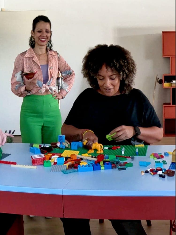 A participant building a LEGO® Serious Play® model during a workshop facilitated by Rafaela Buena
