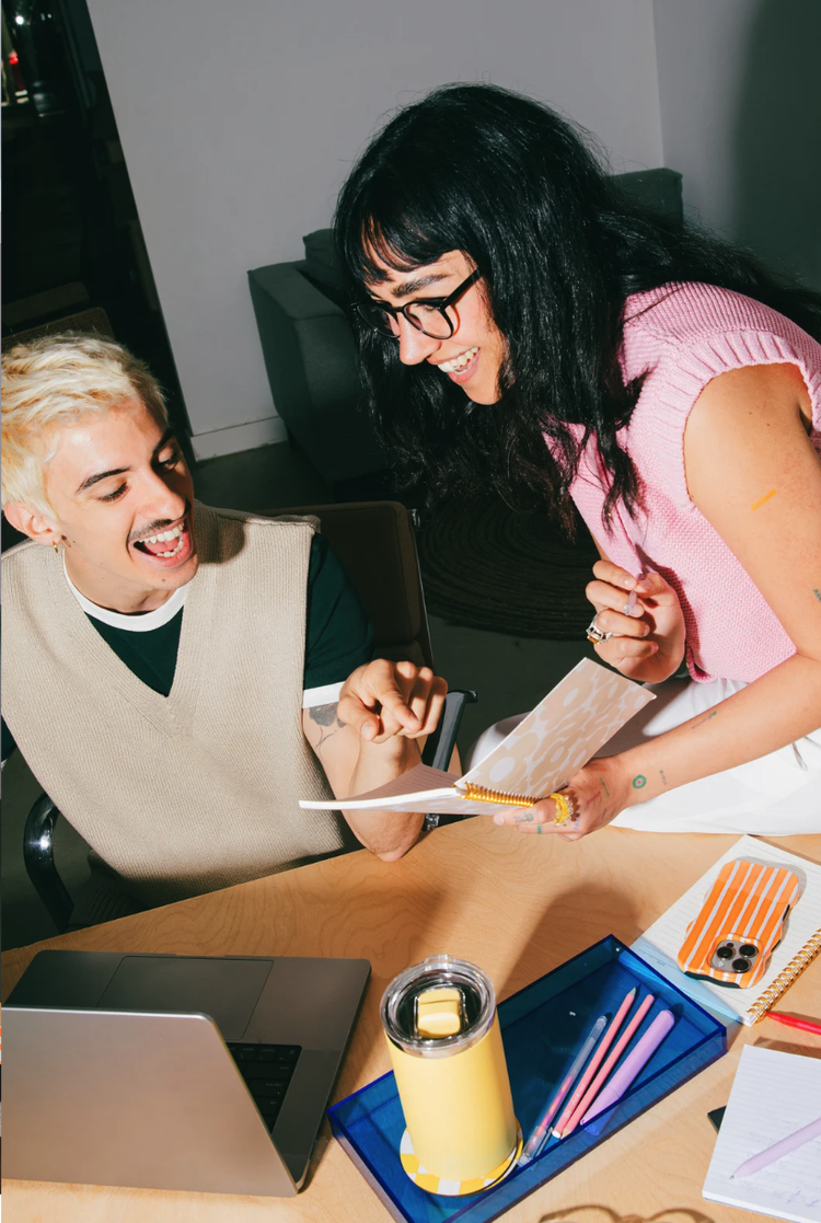 Rafaela Buena laughing with a client over a laptop during a 1:1 session